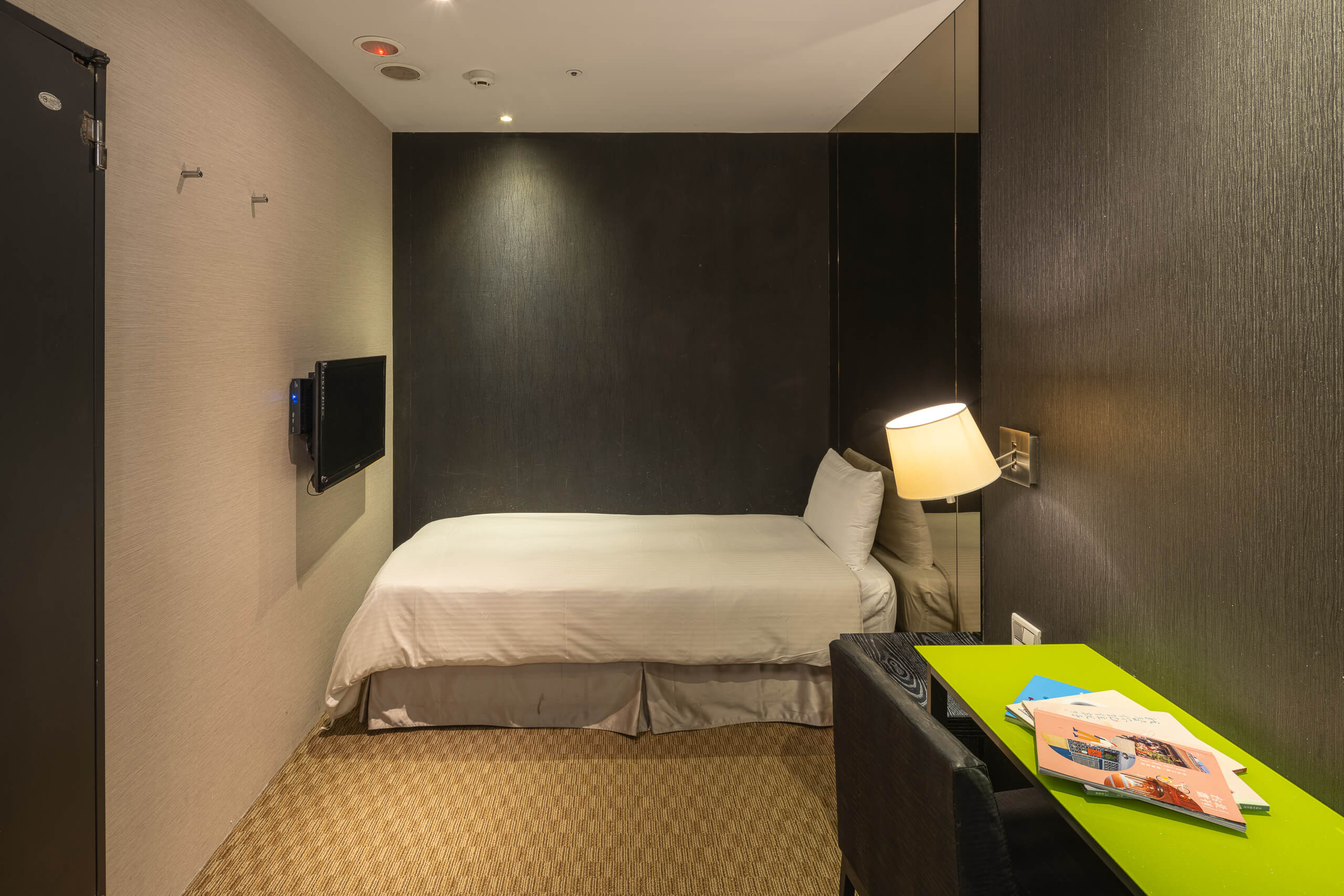 One single bed in the windowless Finders Single Room at Finders Hotel Taipei Fuqian